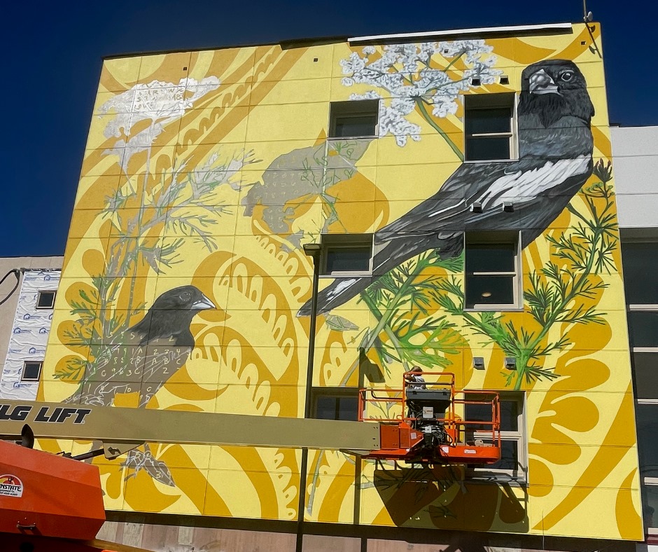 Mural painted by Alex Pangburn on Caraway Apartments, a Maiker Housing Partners Community